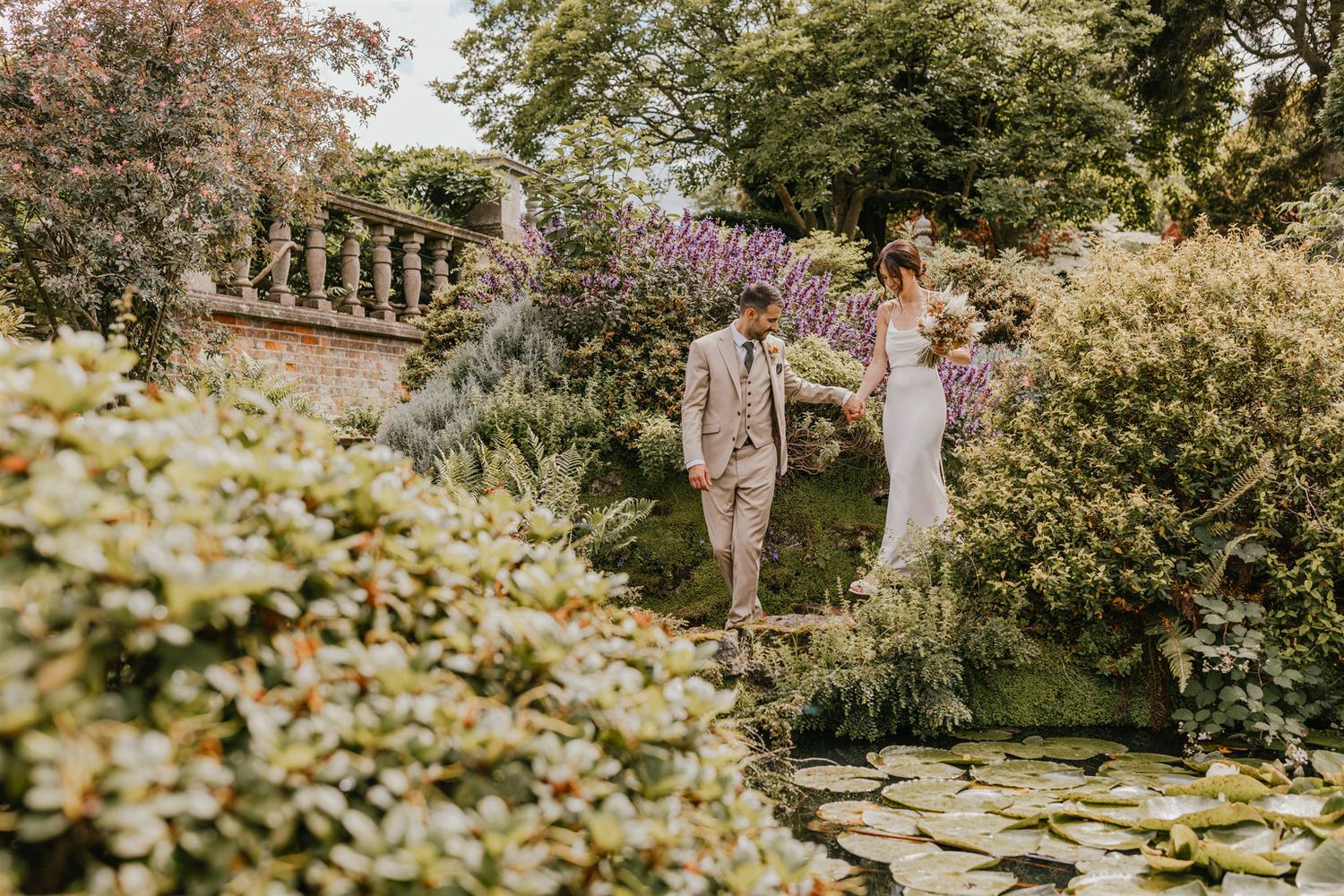 couple portraits in the gardens at mount ephraim wedding venue in kent