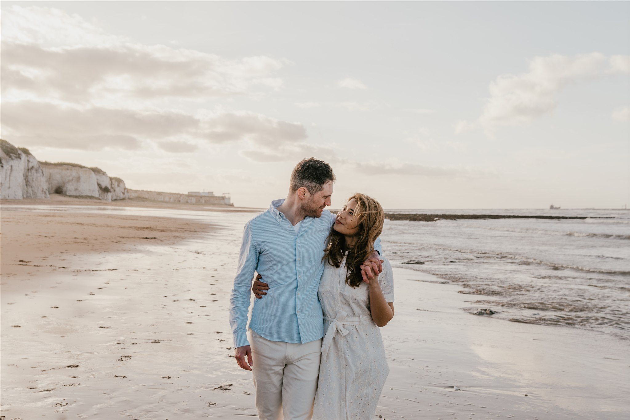 couple walking on the beach at botany bay in broadstairs