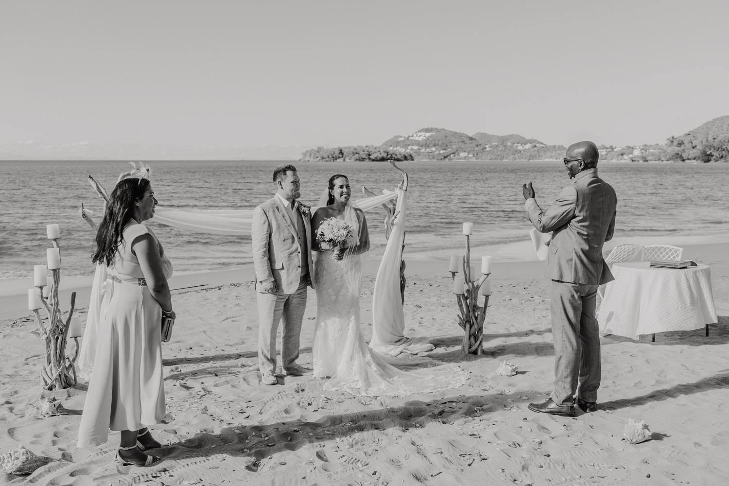 black and white photo of beach wedding ceremony at stolentime resort wedding venue in saint lucia