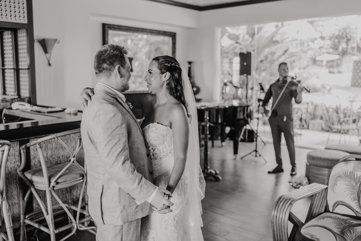 black and white photo of bride and groom first dance in champagne bar at stolentime resort saint lucia wedding venue