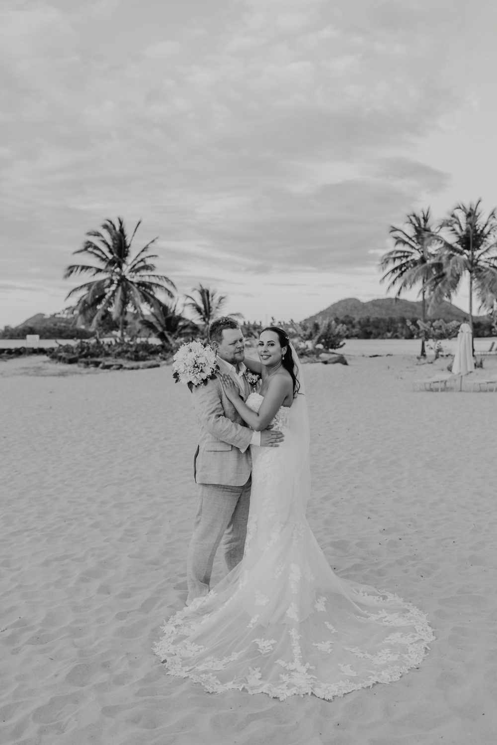 black and white image of bride and groom on the beach at stolentime resort during their saint lucia elopement