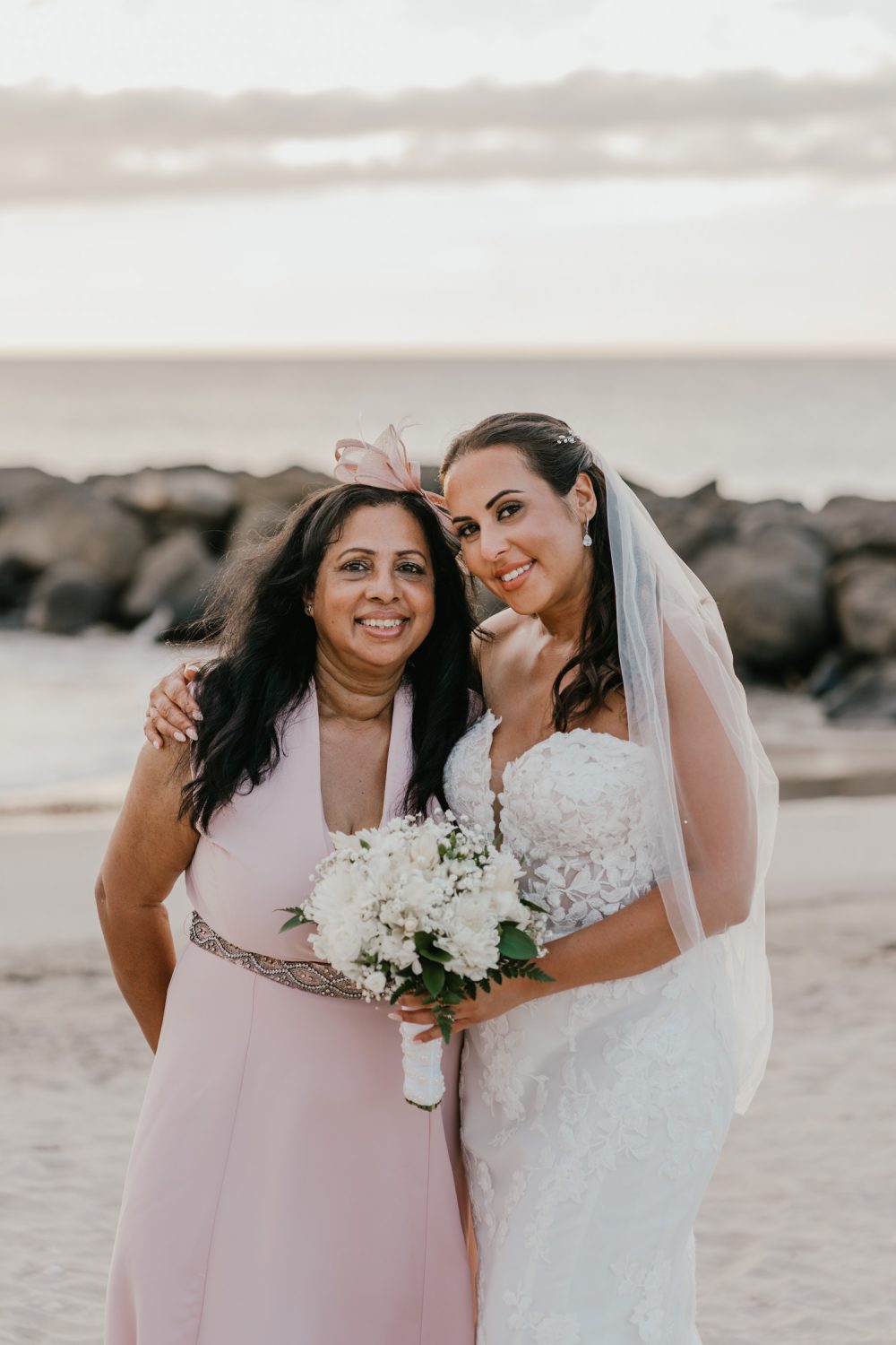 bride and her mum stand together on the beach in saint lucia at stolentime resort wedding