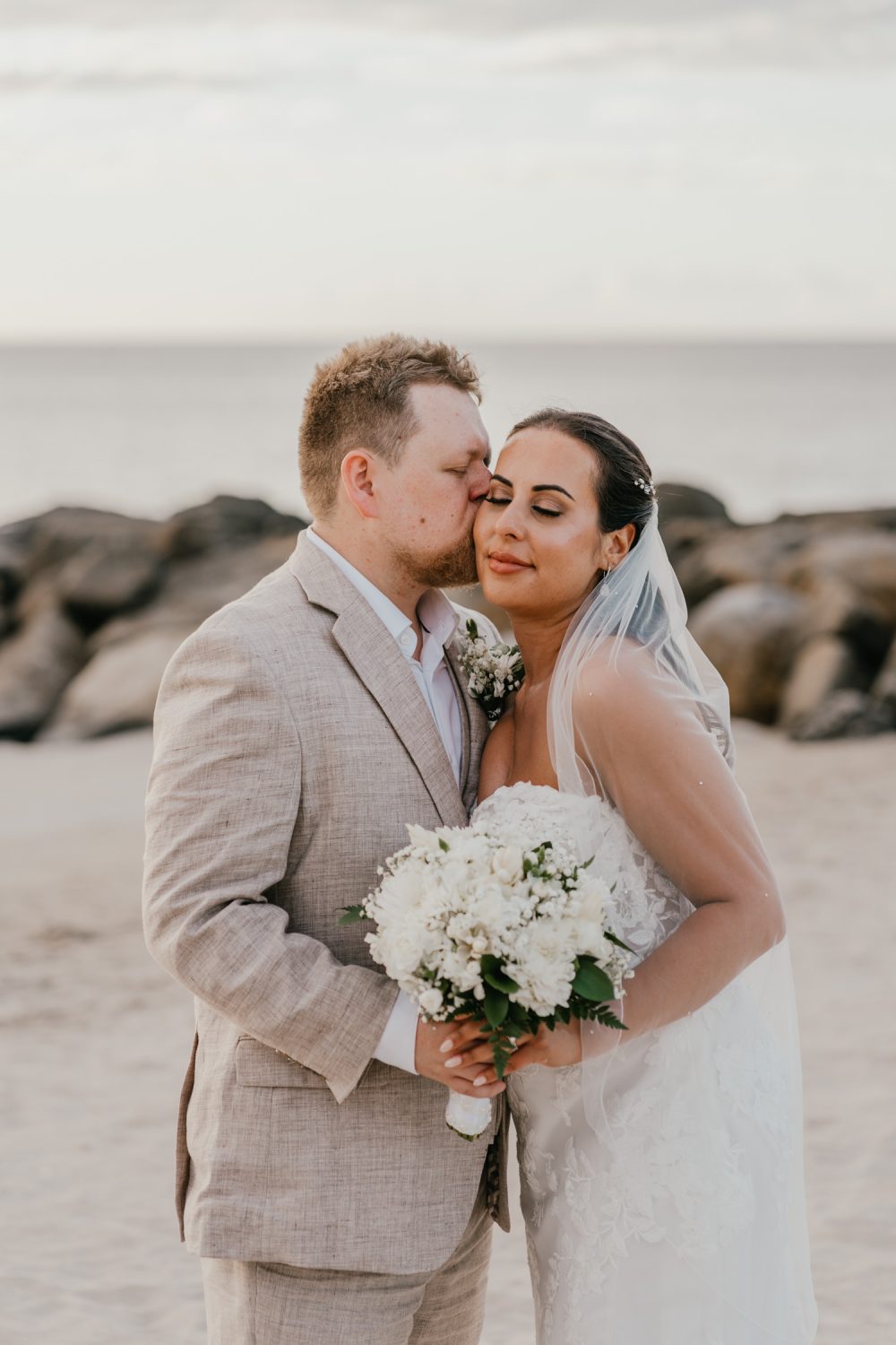 bride and groom stand together on the beach in saint lucia at stolentime resort wedding
