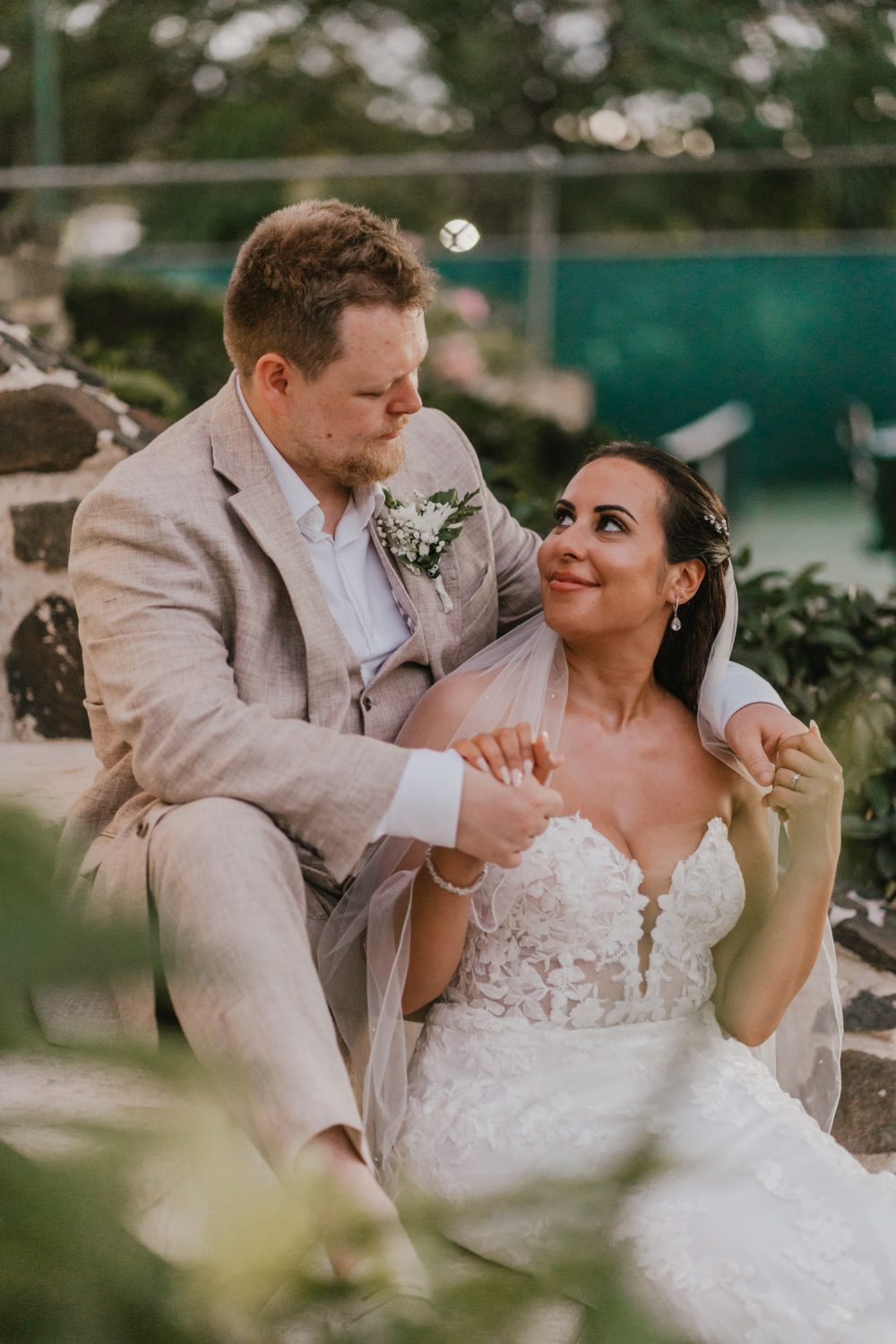 bride and groom sat on steps at stolentime resort wedding in saint lucia
