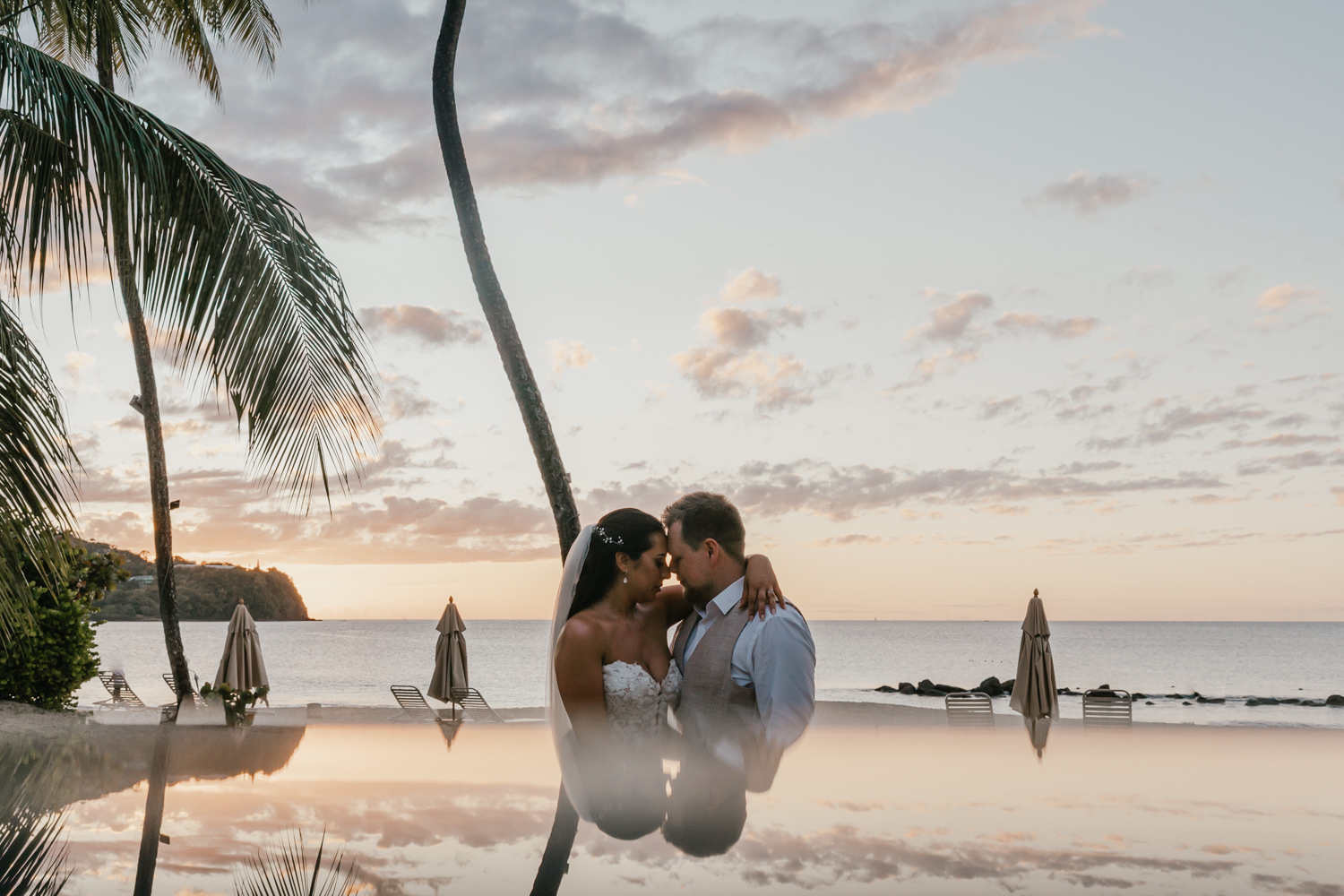 bride and groom on the beach at sunset at stolentime resort in saint lucia