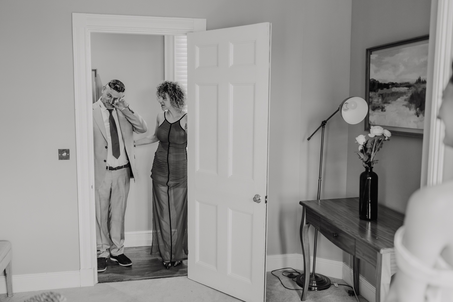 black and white photo of father of the bride crying as he sees his daughter for the first time on her wedding day at northbrook park wedding