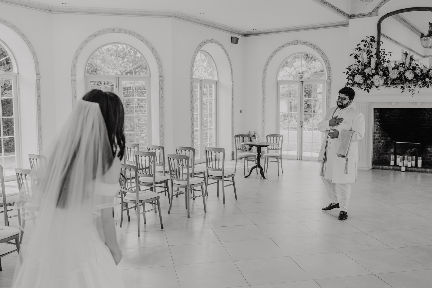 black and white photo of groom's reaction during first look at northbrook park wedding