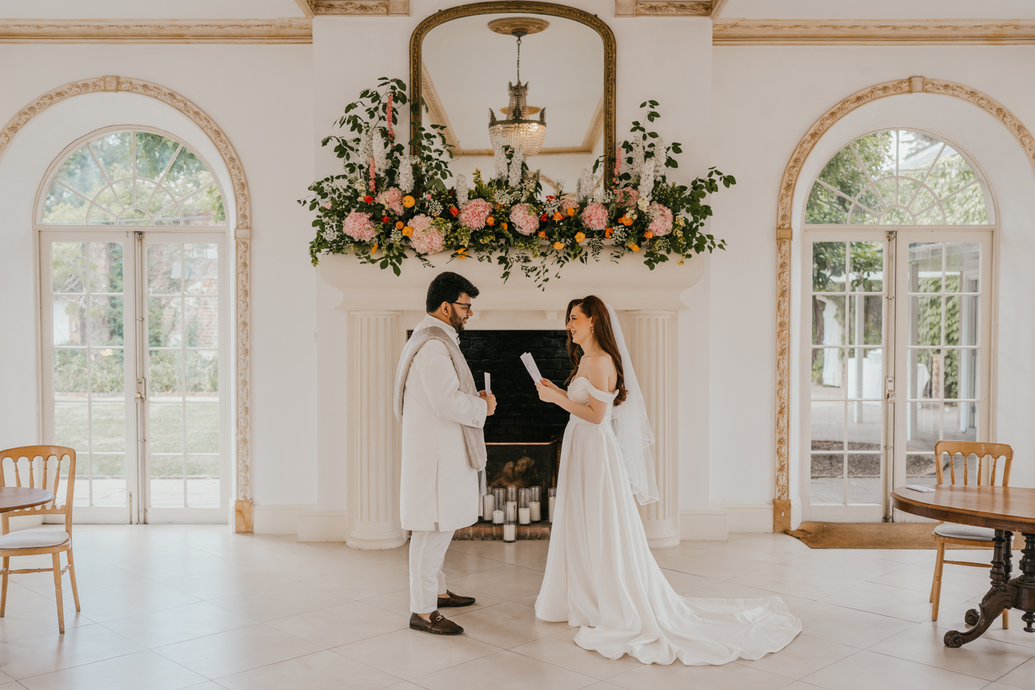 bride and groom exchange private vows during first look in front of the fireplace at northbrook park wedding venue