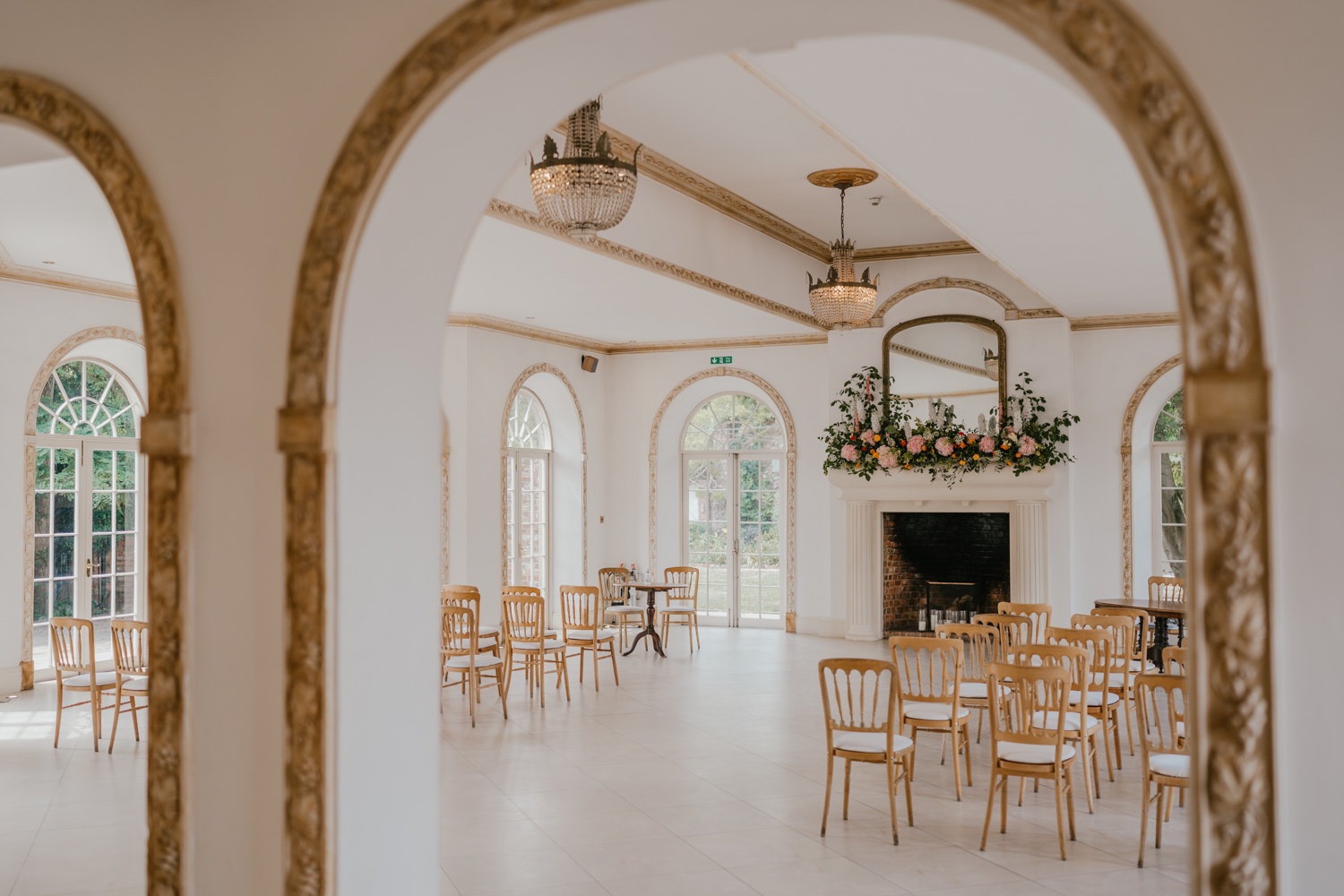 floral display on the fireplace for wedding ceremony at northbrook park