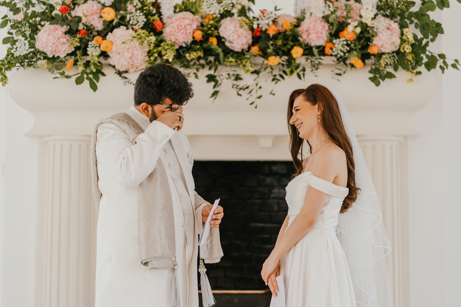 bride and groom exchange private vows during first look in front of the fireplace at northbrook park wedding venue