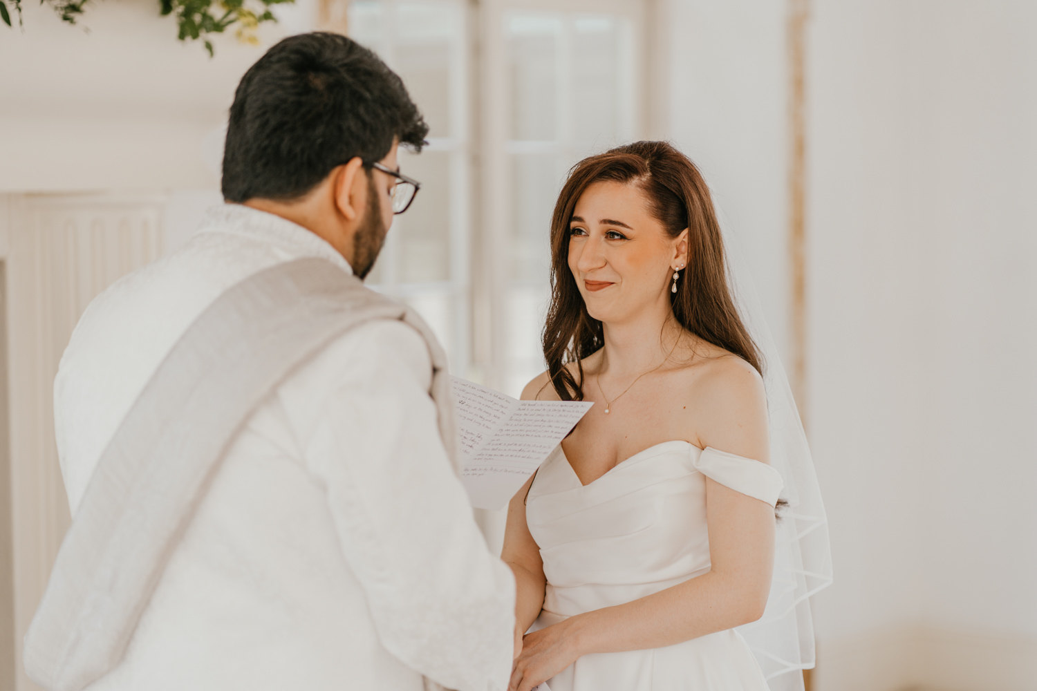 bride and groom exchange private vows during first look in front of the fireplace at northbrook park wedding venue