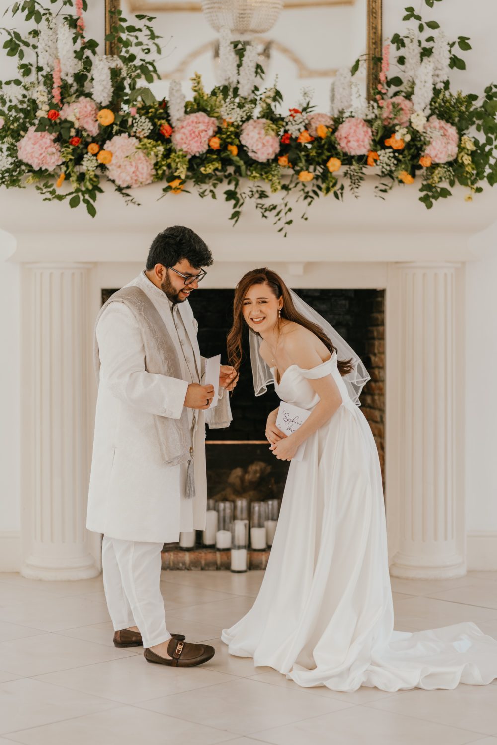 bride and groom exchange private vows during first look in front of the fireplace at northbrook park wedding venue