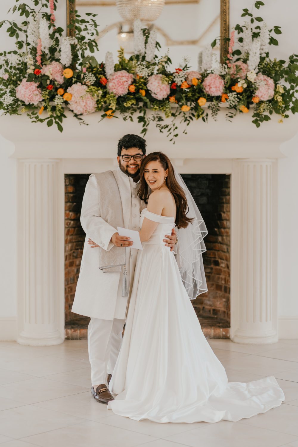bride and groom smile during first look at northbrook park wedding