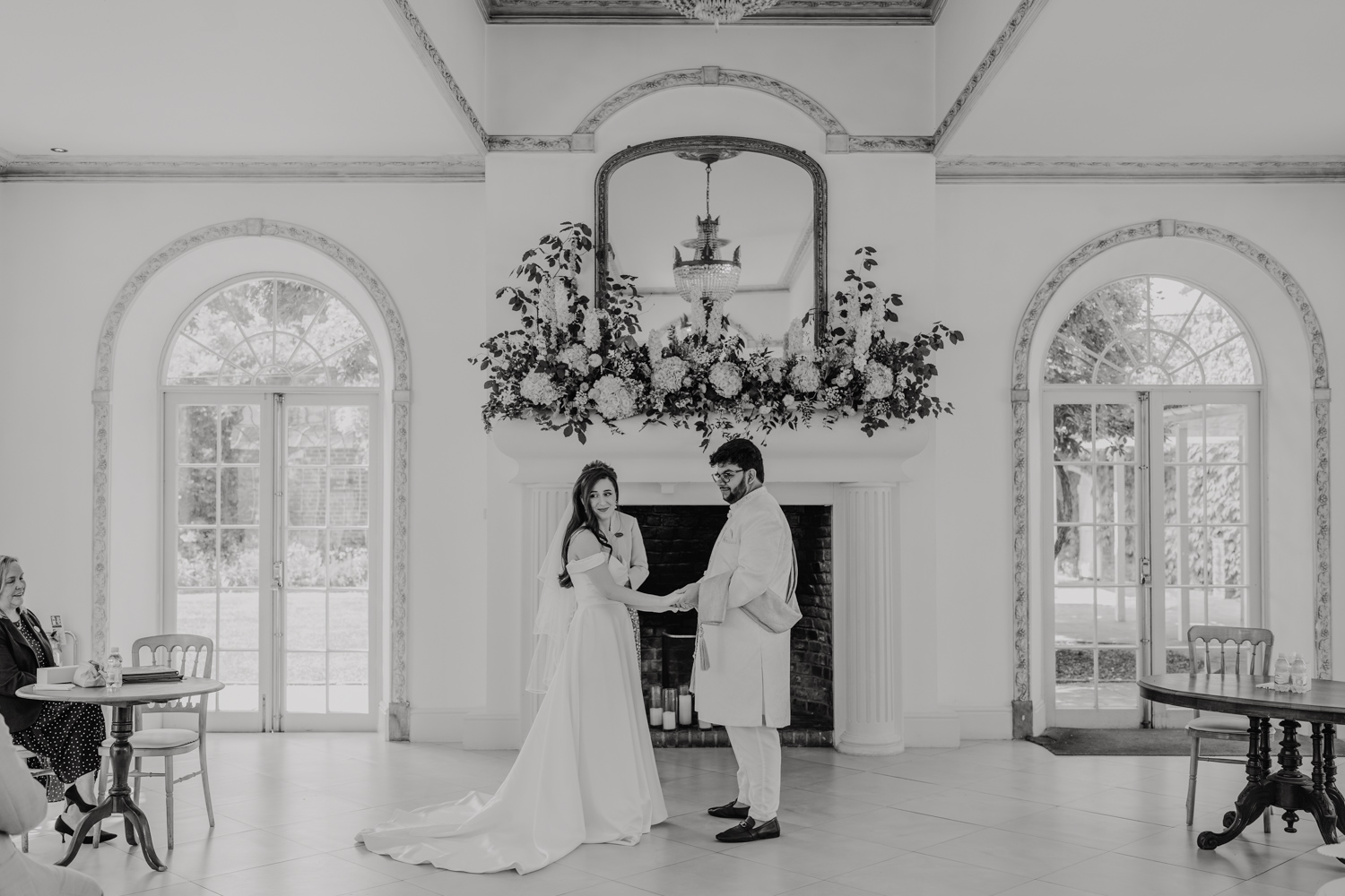 black and white image of bride and groom exchanging vows at northbrook park wedding