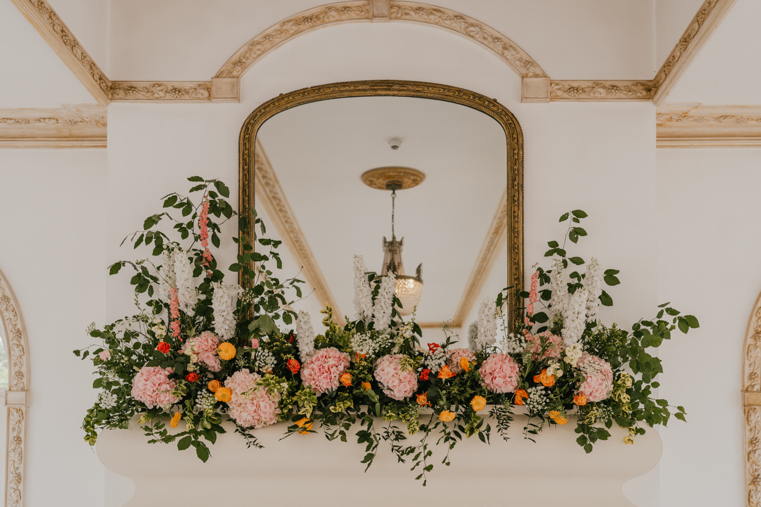 floral display on the fireplace for wedding ceremony at northbrook park