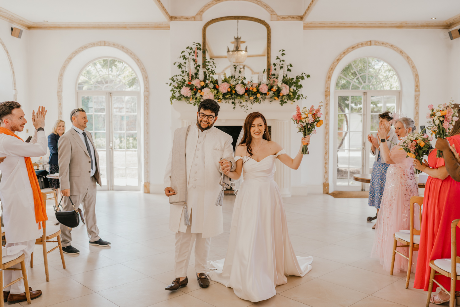 bride and groom recessional after wedding ceremony at northbrook park in farnham