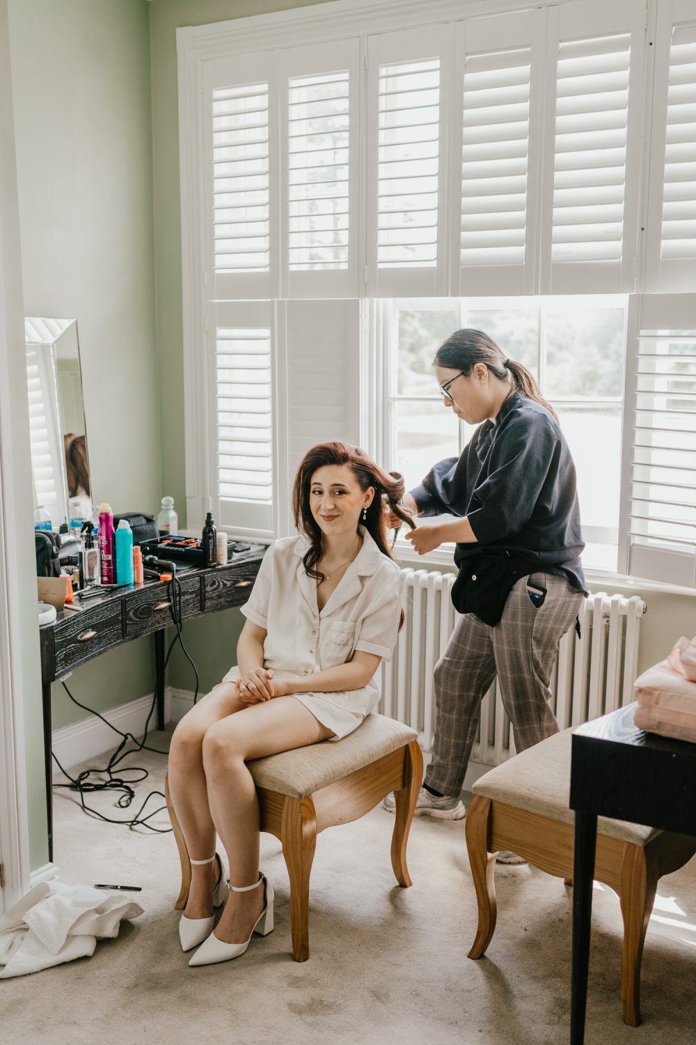 bride getting her hair done on wedding morning at northbrook park