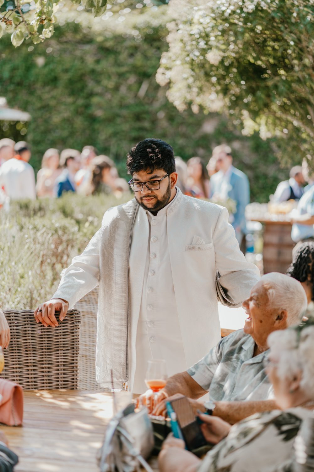 groom candid during drinks reception at northbrook park wedding