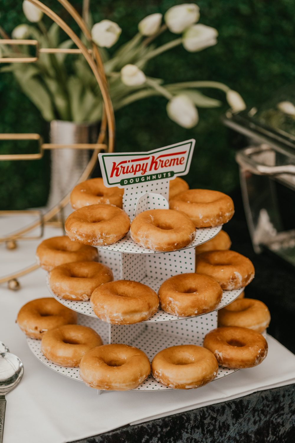 krispy kreme doughnut stand on dessert table