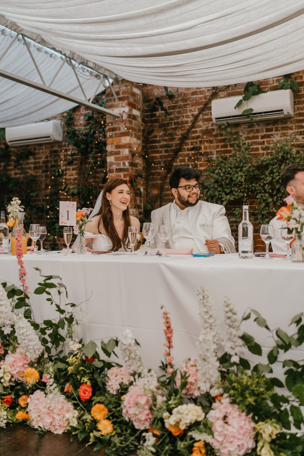 bride and groom react to best man's speech at northbrook park wedding