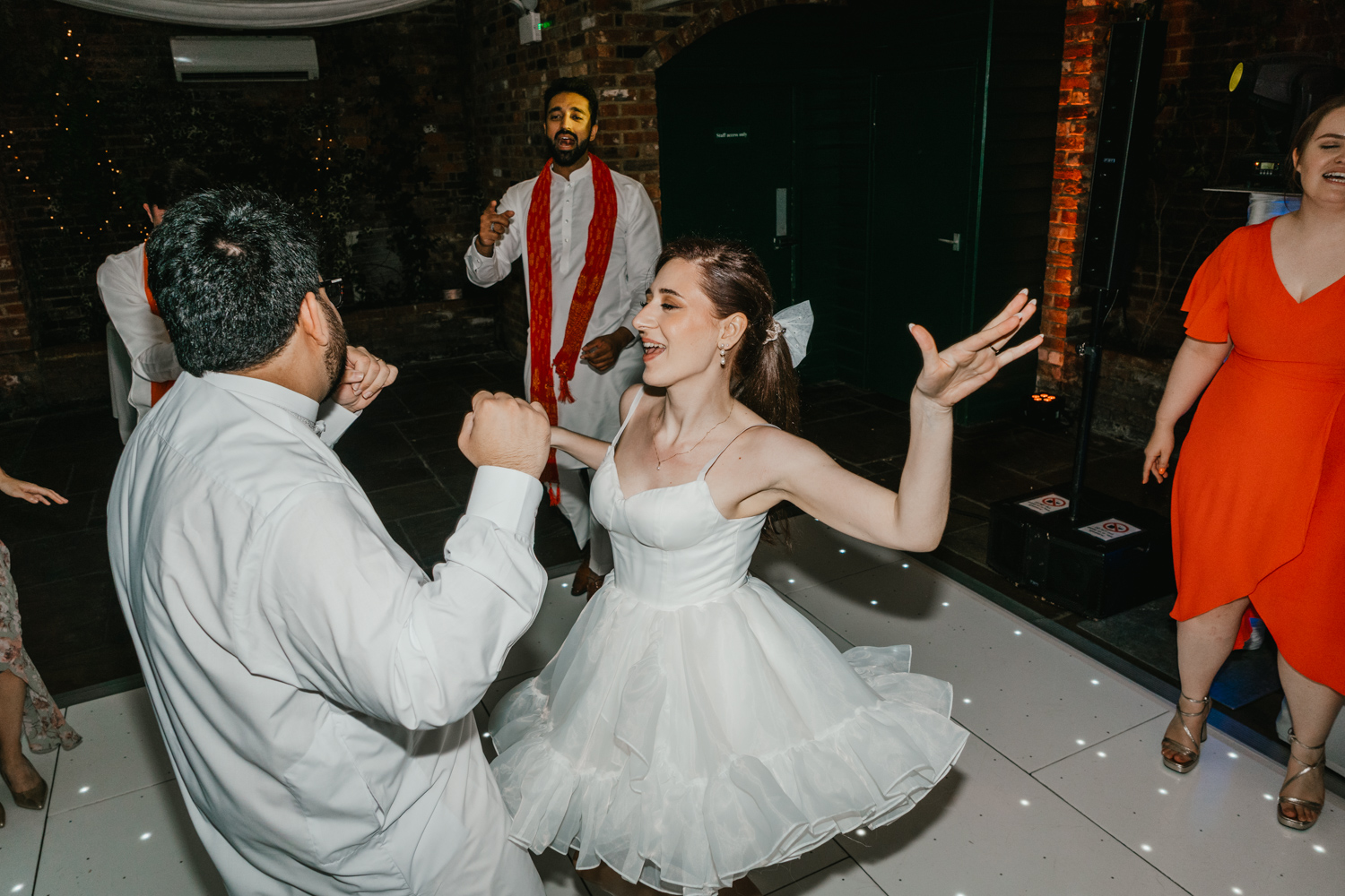 bride dances in mini dress on dance floor at northbrook park wedding