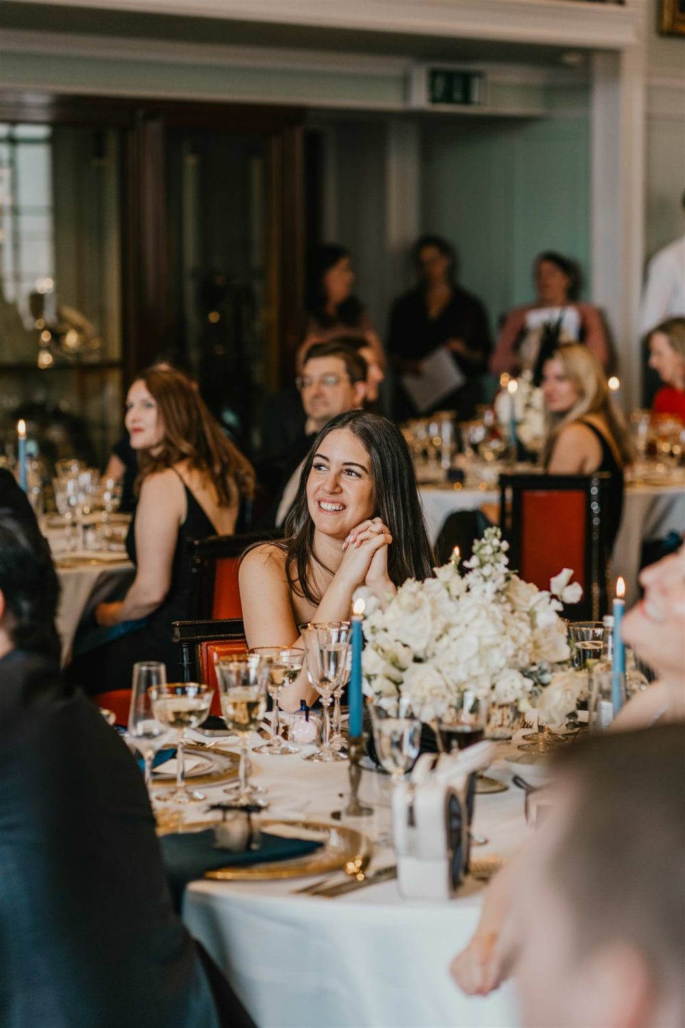 wedding guests reaction to speeches in the library at trinity house wedding venue in london