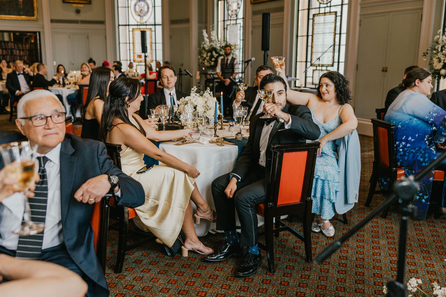 wedding guests reaction to speeches in the library at trinity house wedding venue in london