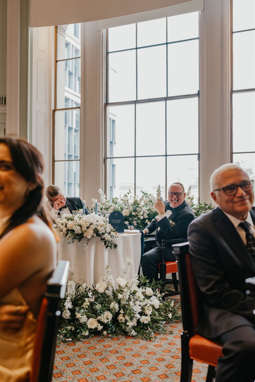 grooms reaction to speeches in the library at trinity house wedding venue in london