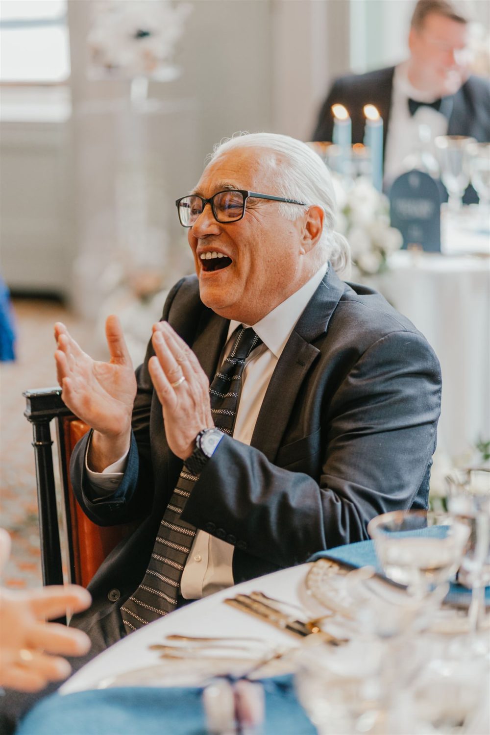 wedding guests reaction to speeches in the library at trinity house wedding venue in london