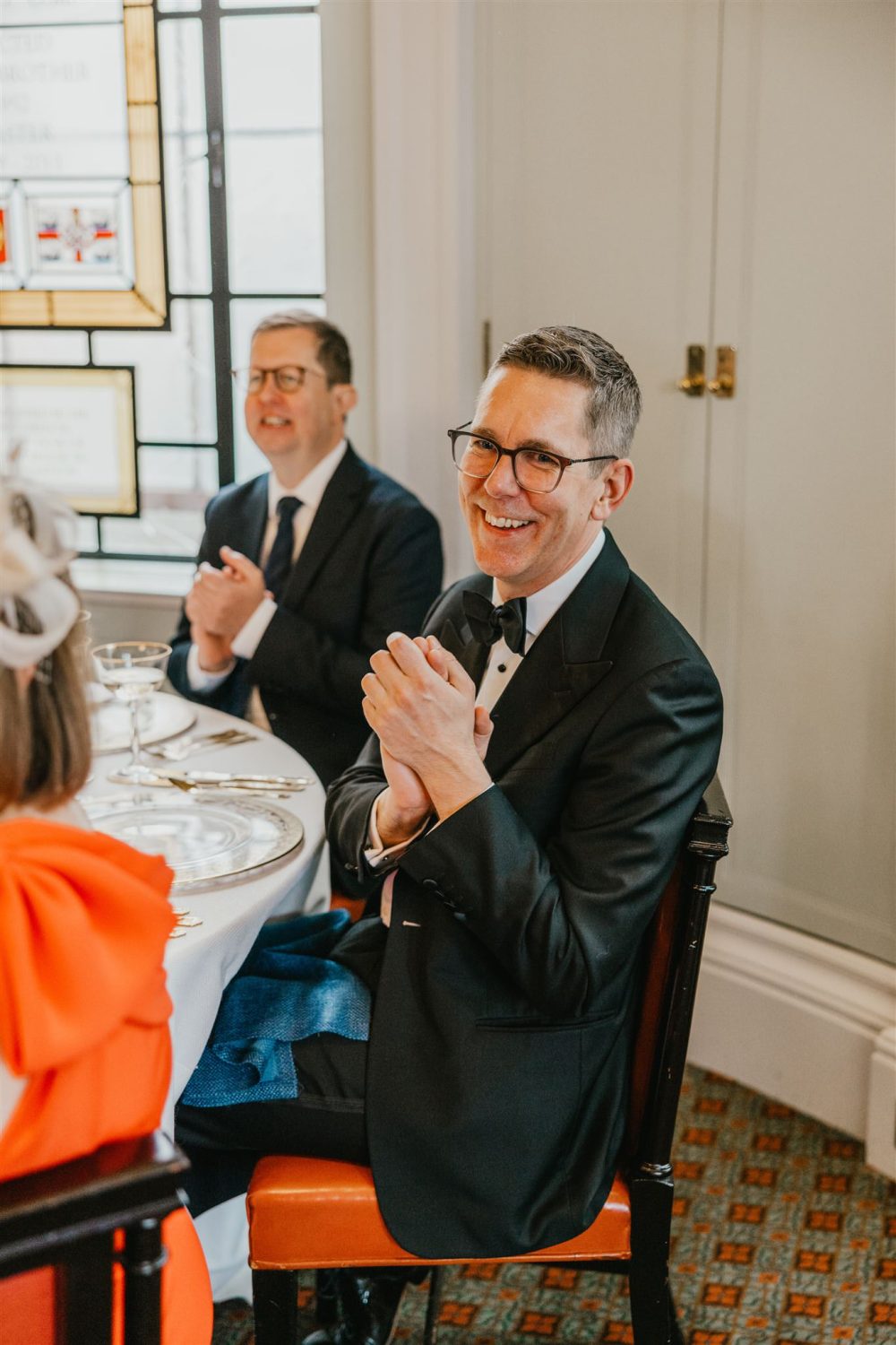wedding guests reaction to speeches in the library at trinity house wedding venue in london