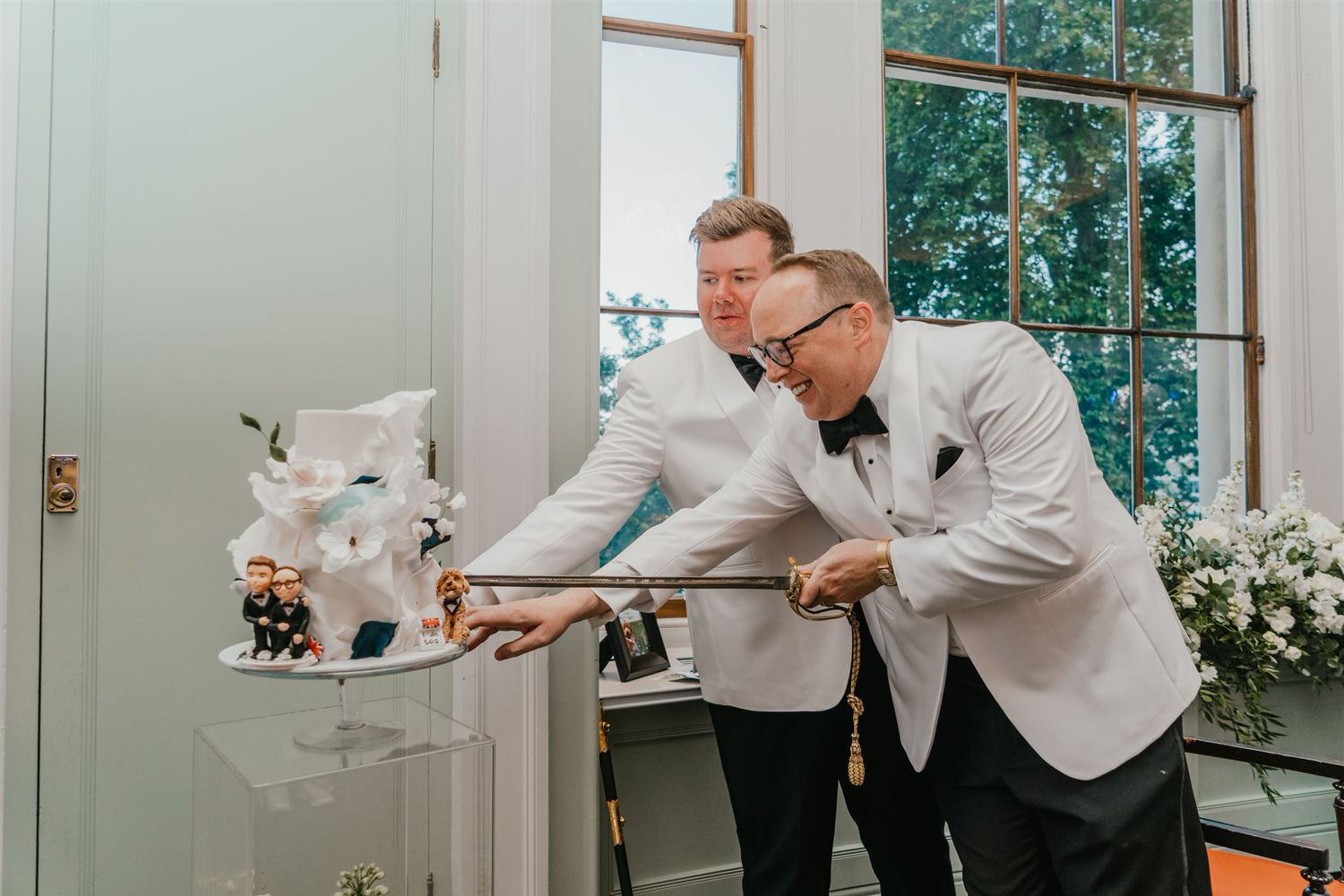 grooms cut wedding cake at trinity house wedding in london
