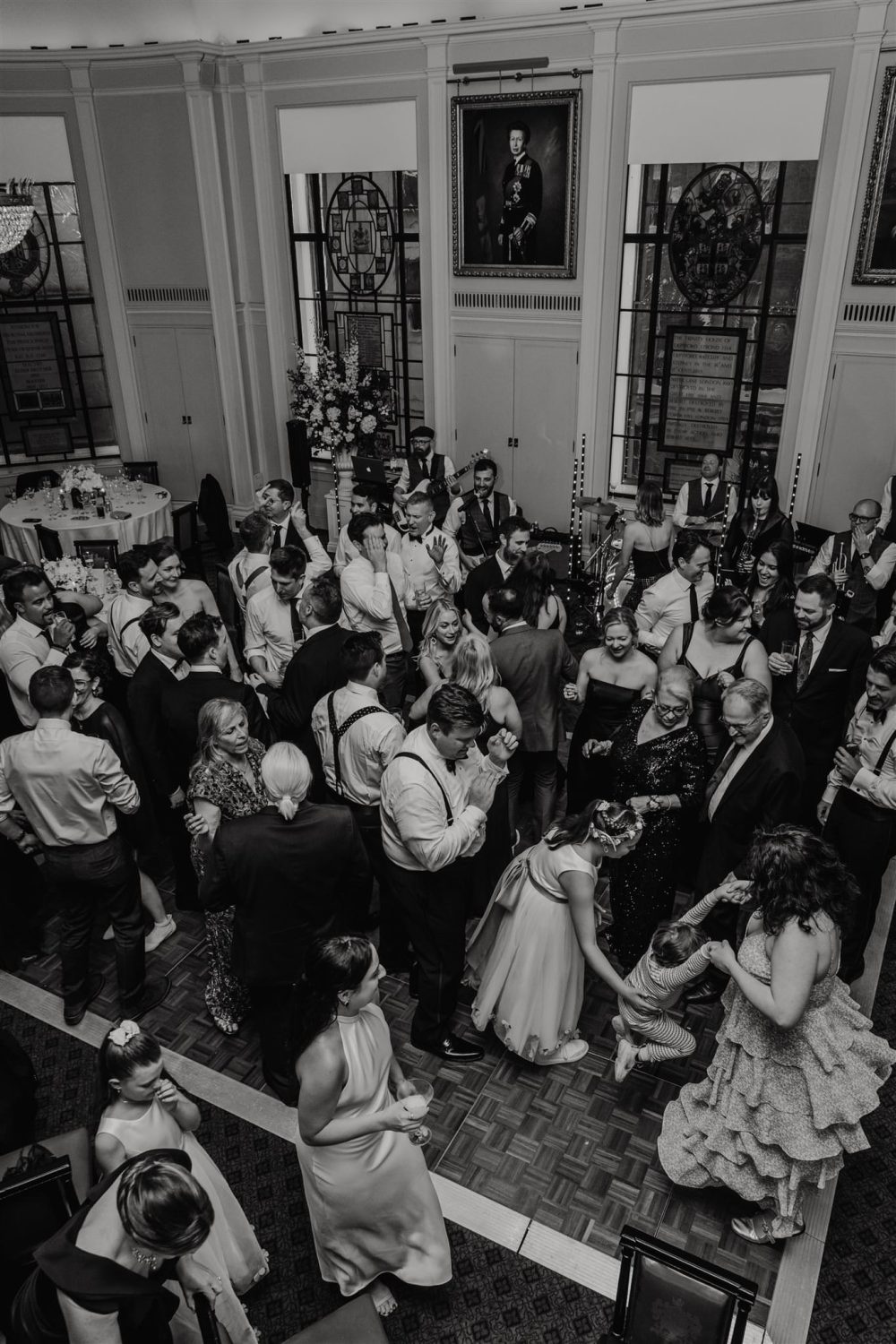 black and white photo of wedding guests on the dance floor at trinity house wedding in london