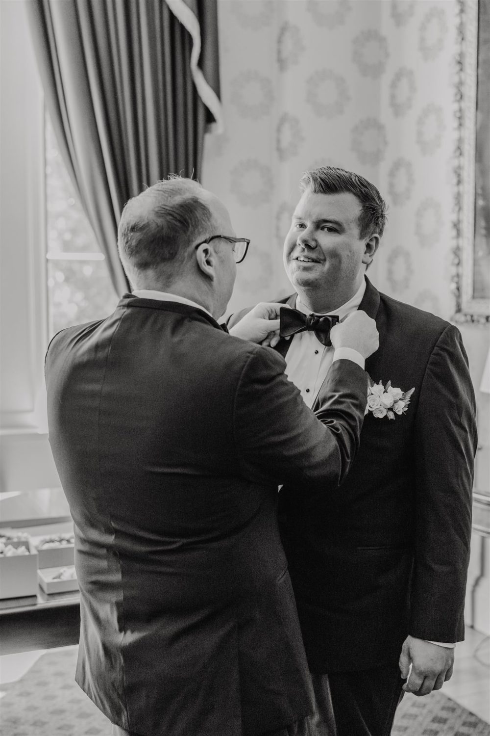 black and white photo of grooms getting ready at trinity house london wedding