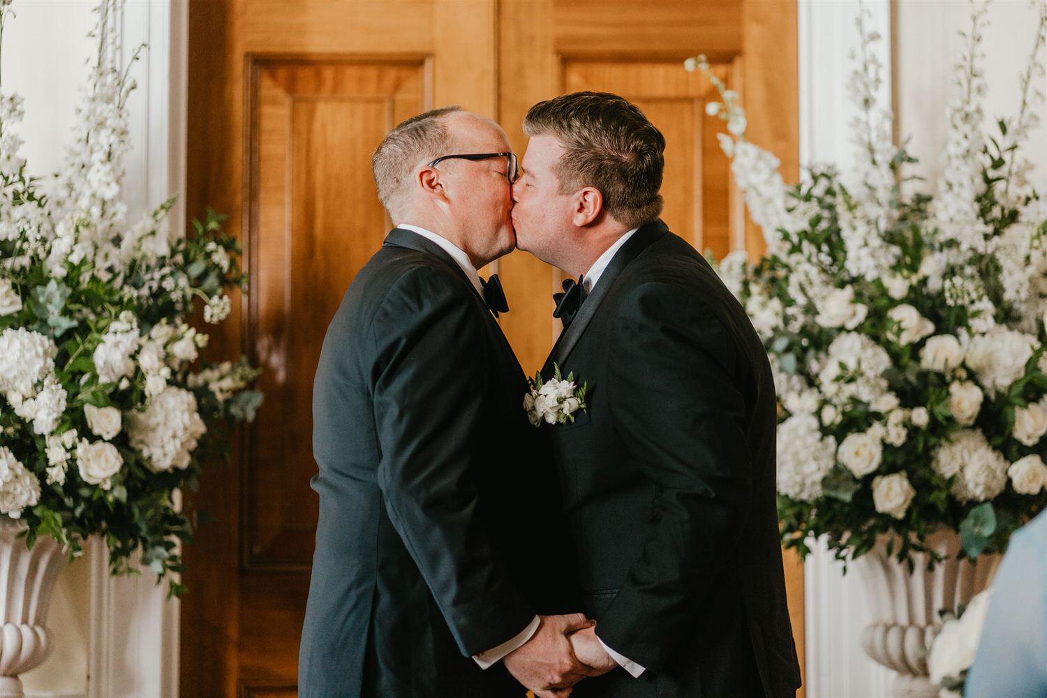 grooms first kiss during trinity house wedding ceremony in the court room
