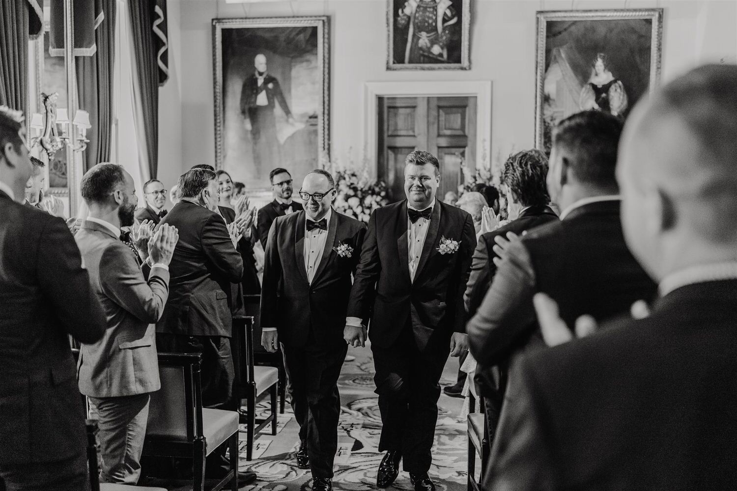 black and white photo of grooms recessional after trinity house wedding ceremony in the court room