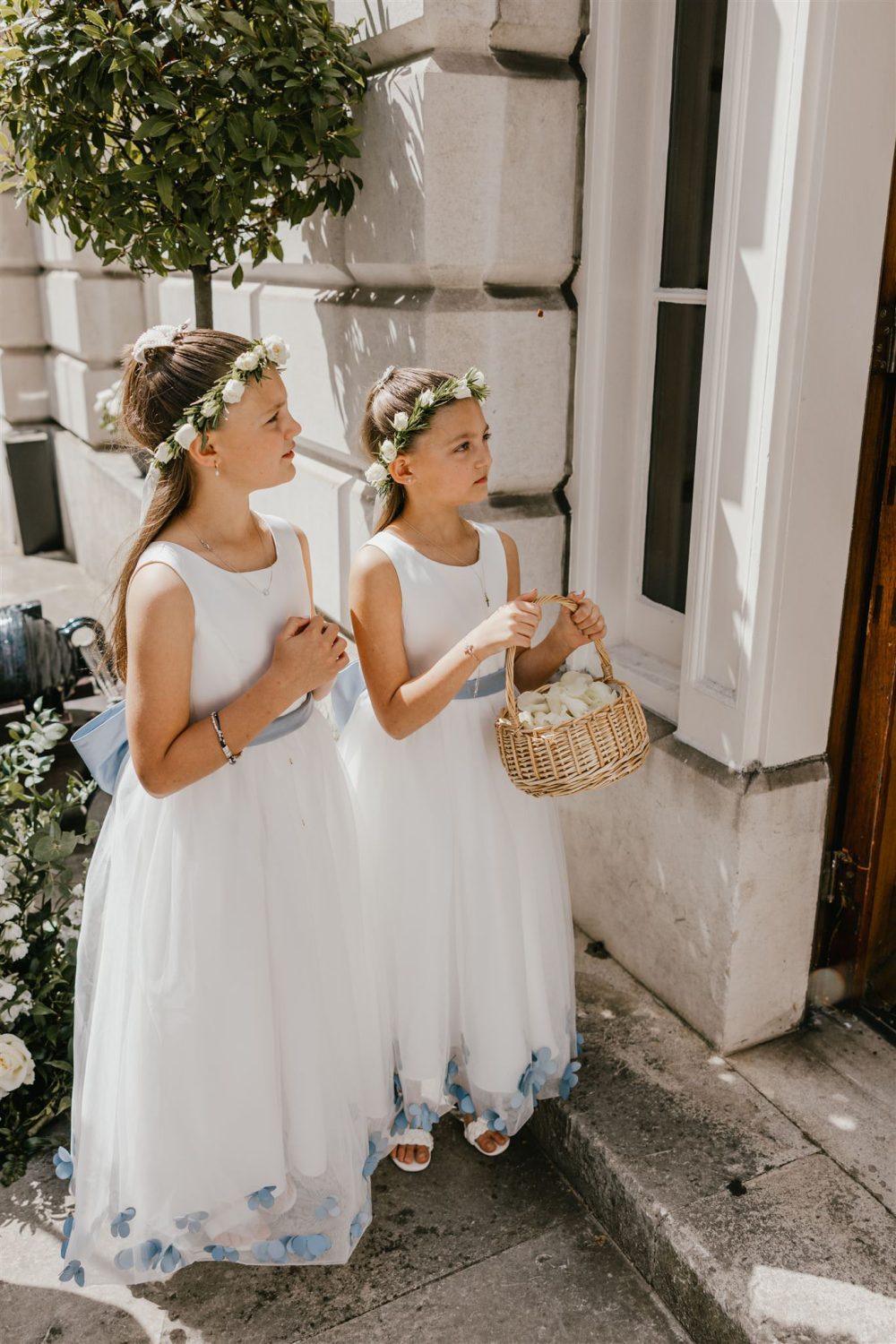 flower girls handing out confetti after wedding ceremony at trinity house in london
