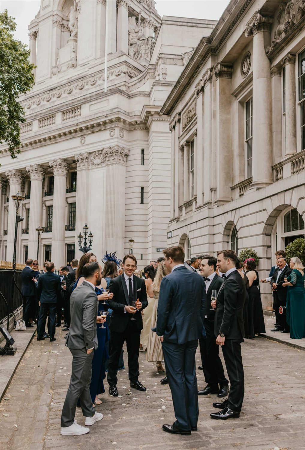 wedding guests during drinks reception outside trinity house wedding in london