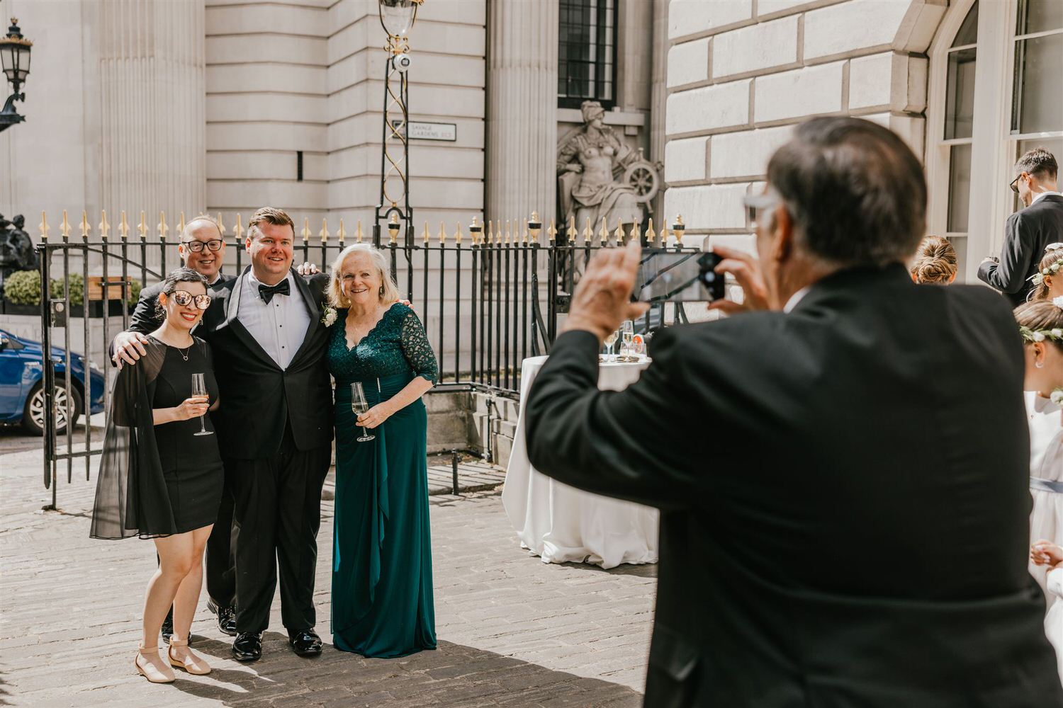 wedding guests during drinks reception outside trinity house wedding in london