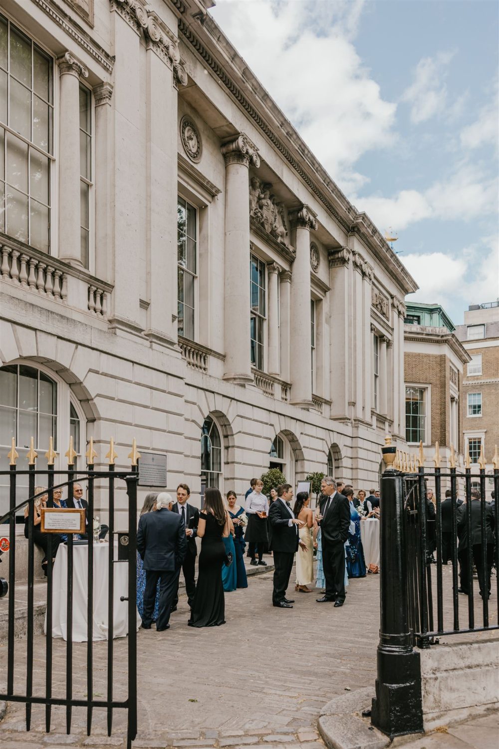 wedding guests during drinks reception outside trinity house wedding in london