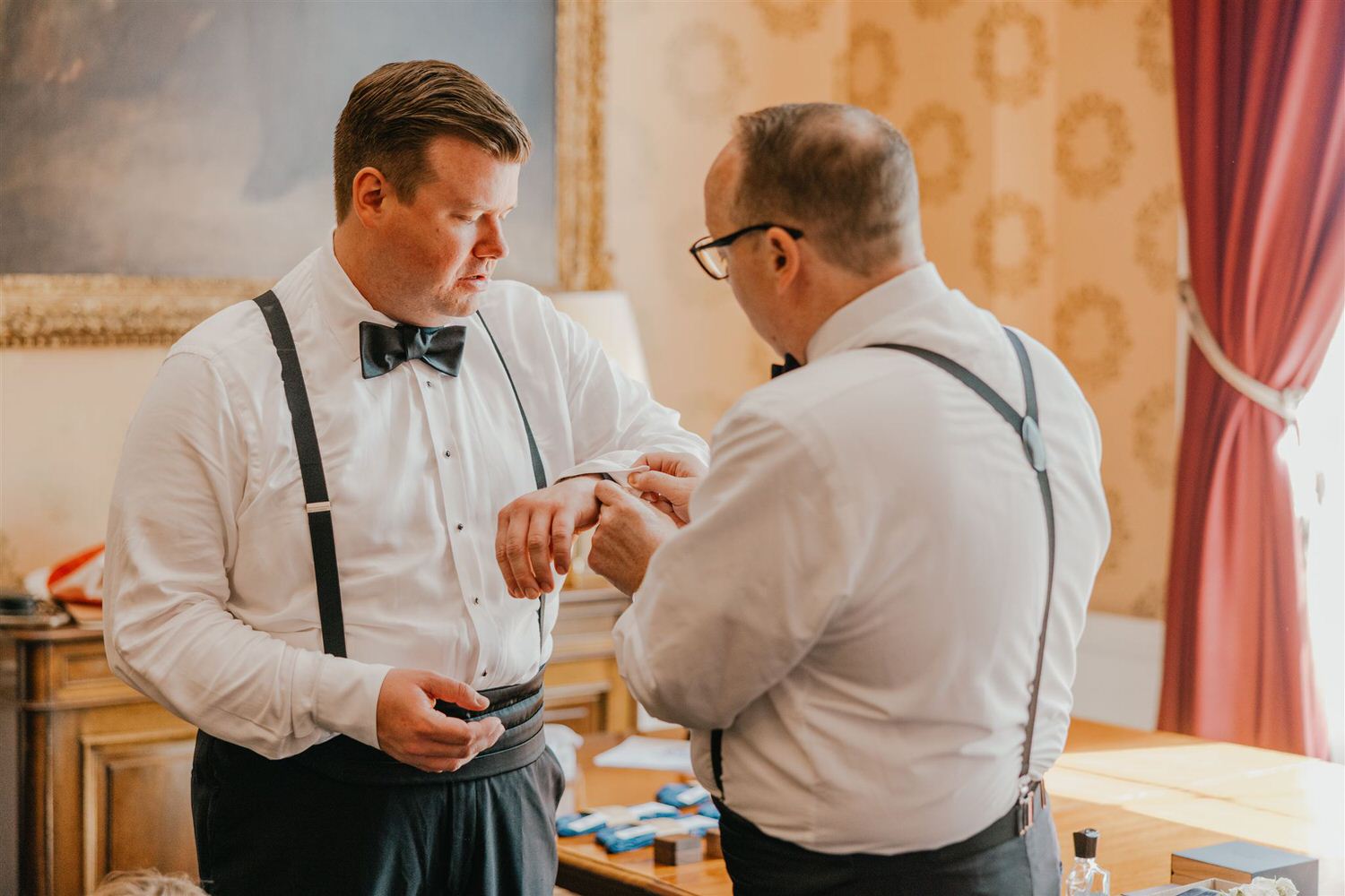 grooms putting on cufflinks before trinity house wedding in london