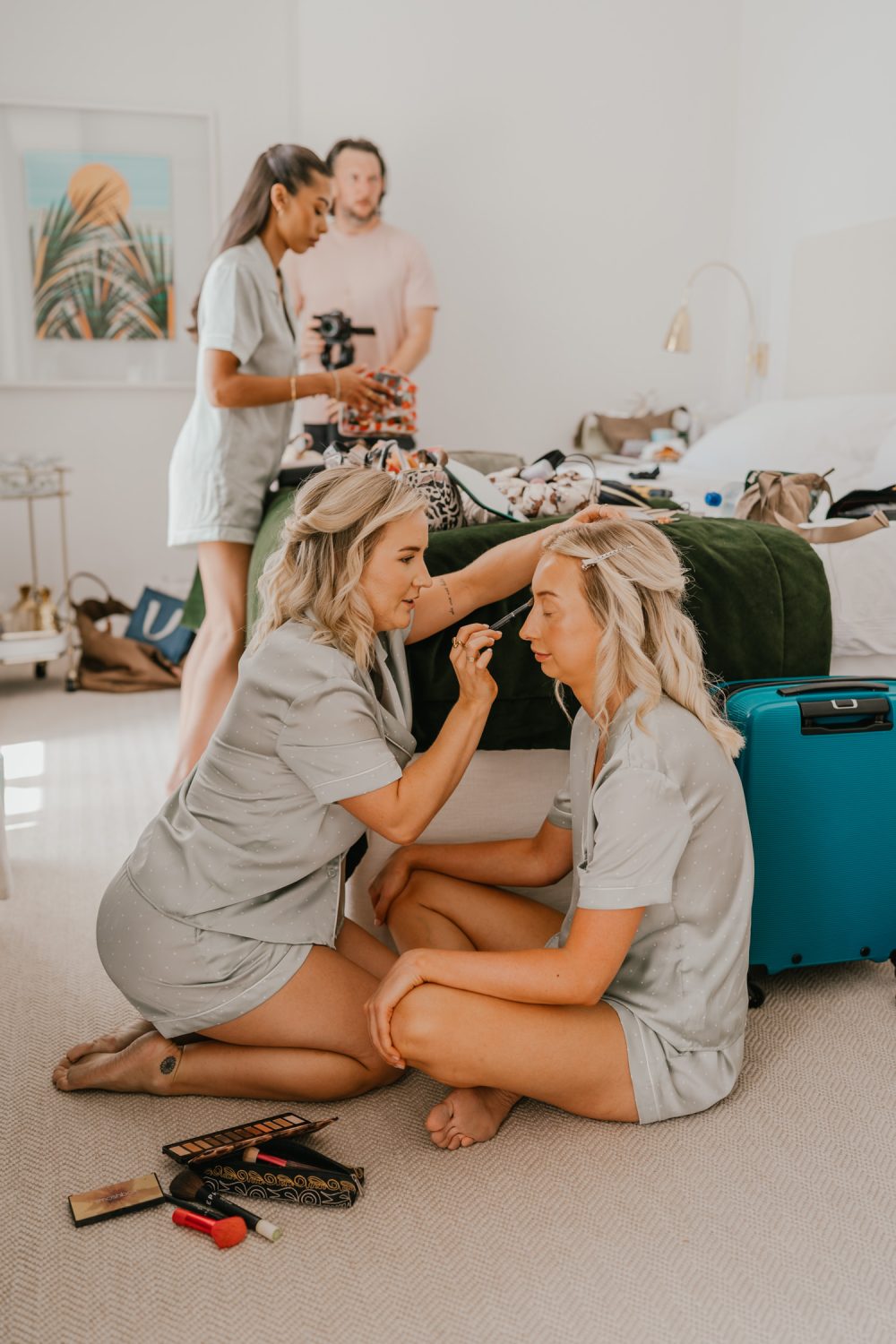 bridesmaids doing makeup on wedding morning