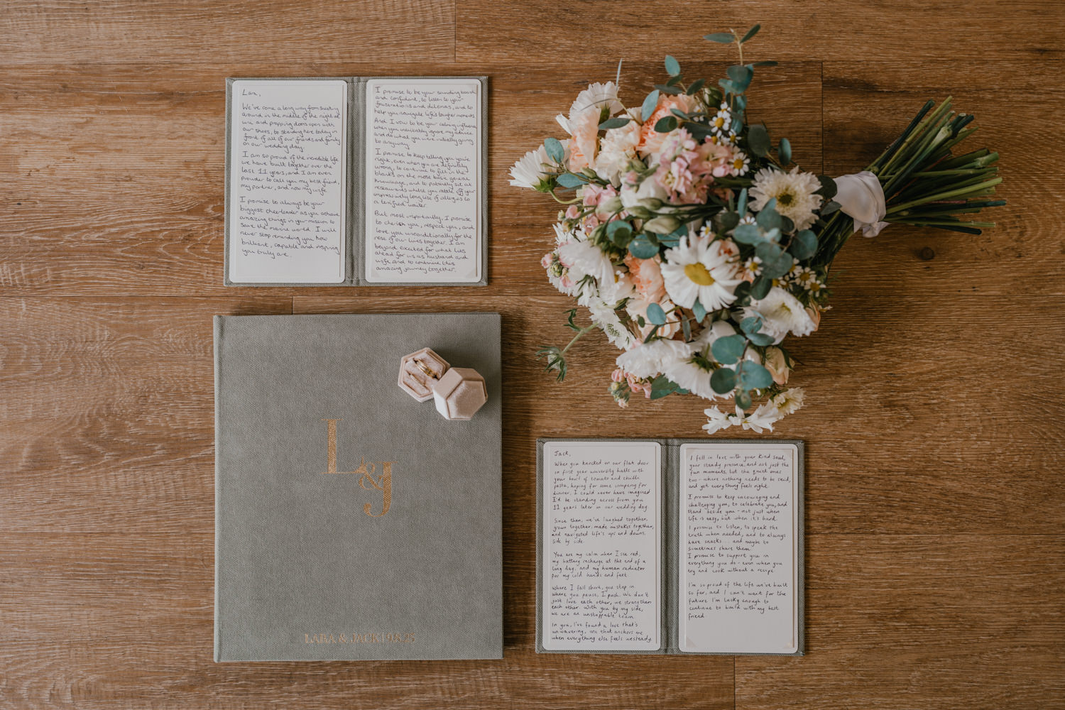 wedding vow books with flowers and wedding rings