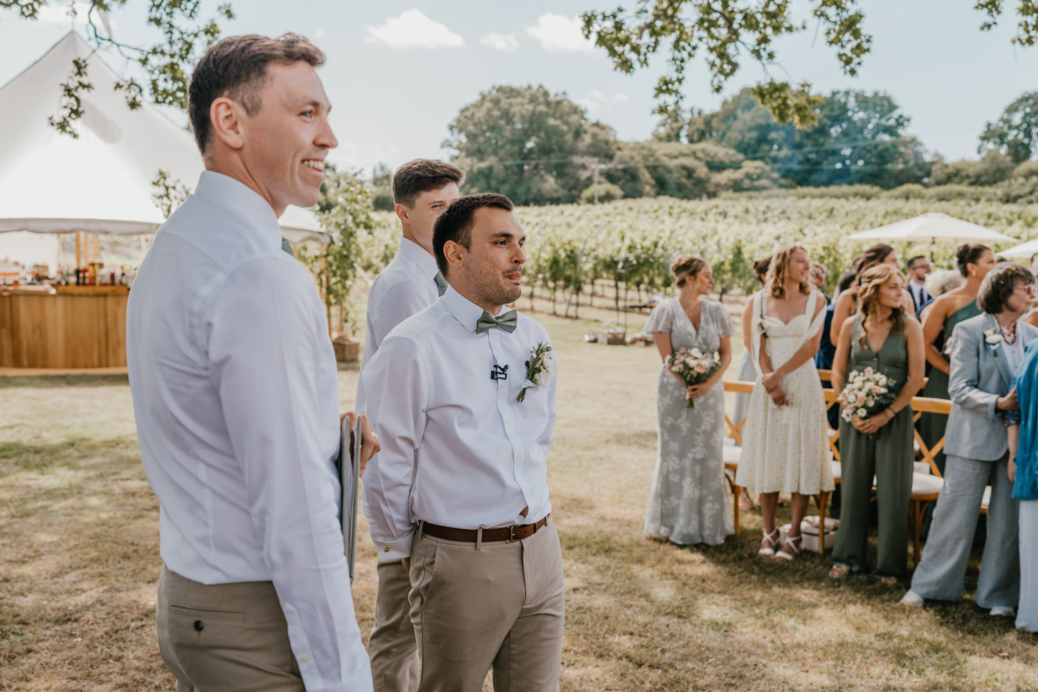 groom waits for bride at vineyard wedding ceremony at English Oak Vineyard