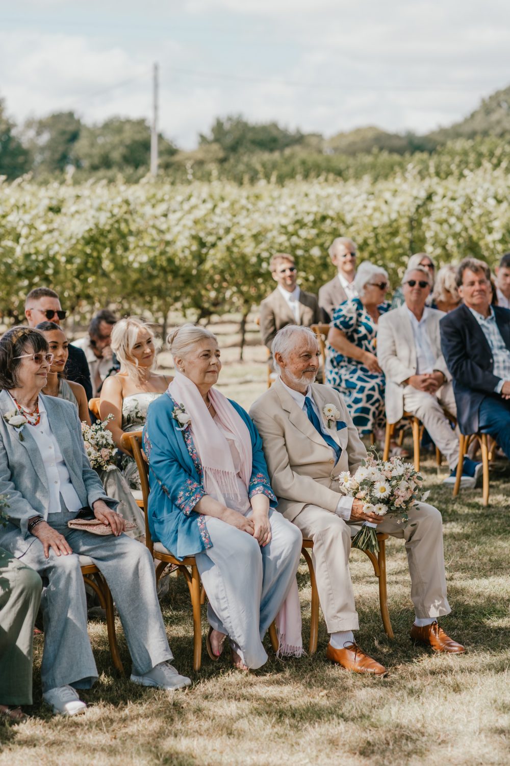 parents of the bride watch vineyard wedding ceremony at English Oak Vineyard