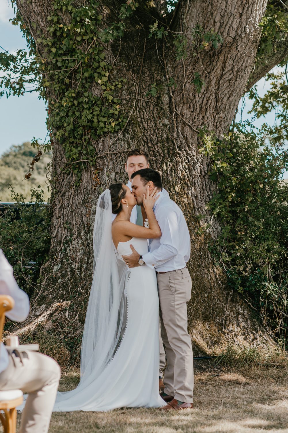 bride and groom first kiss at vineyard wedding ceremony at English Oak Vineyard