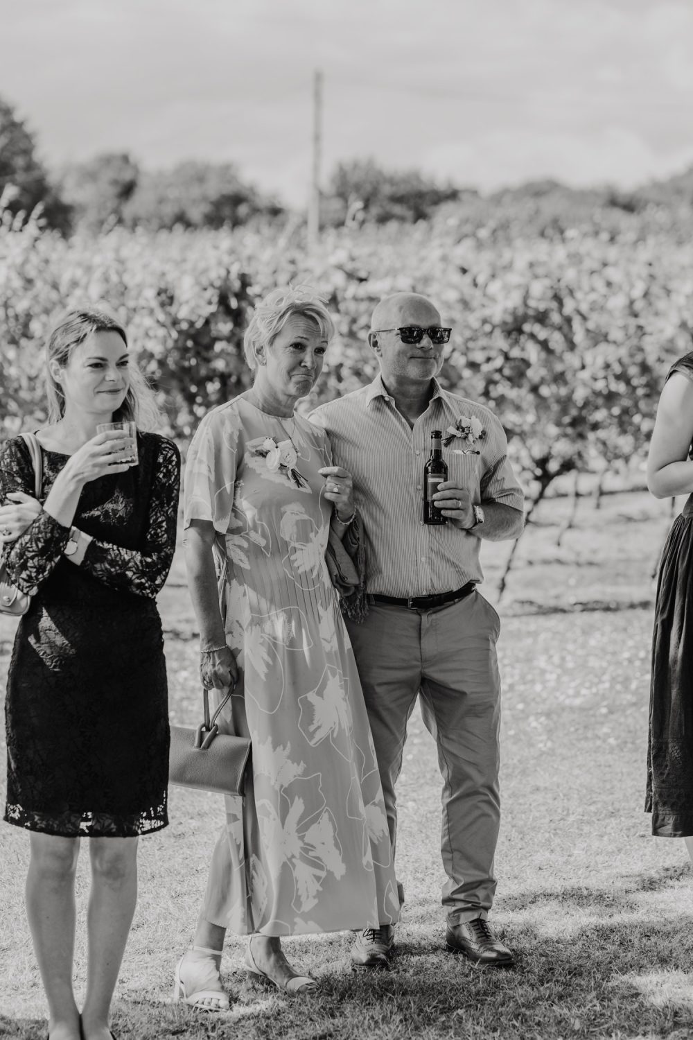 black and white photo of guest reaction during outdoor speeches at English Oak Vineyard wedding in dorset