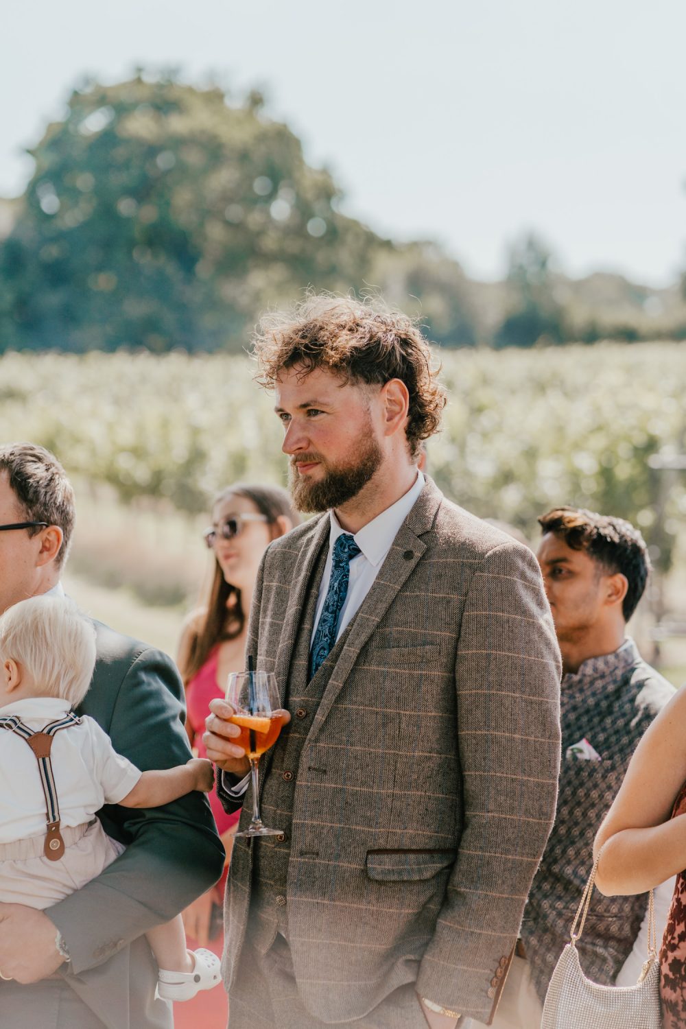 guest candid during outdoor speeches at English Oak Vineyard wedding in dorset