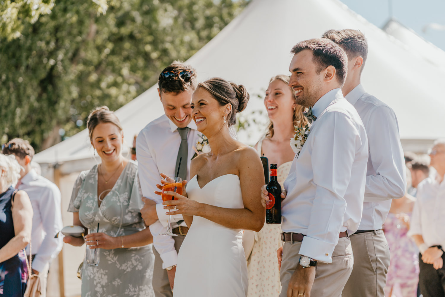 bride smiles during outdoor speeches at English Oak Vineyard wedding in dorset