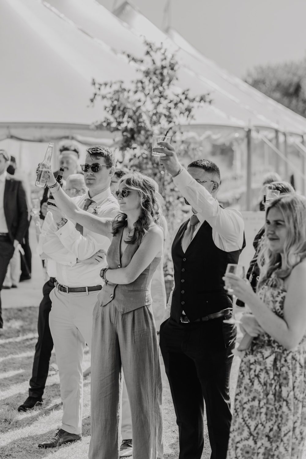 black and white guest candid during outdoor speeches at English Oak Vineyard wedding in dorset
