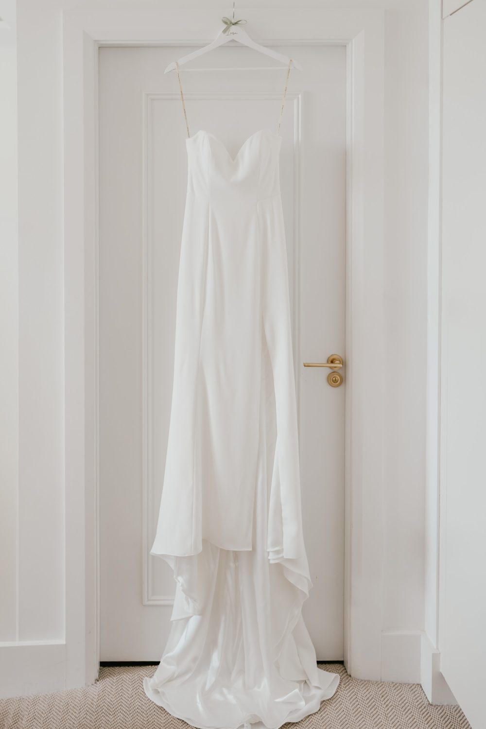 wedding dress hanging in bridal suite